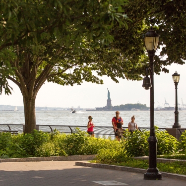 View of the Statue of Liberty and waterfront in Battery Park City in Lower Manhattan.