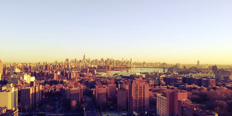 Panoramic view of the New York City skyline taken from Brooklyn at sunrise showing the boroughs of Manhattan, Brooklyn, Queens and The Bronx as well as the East River.