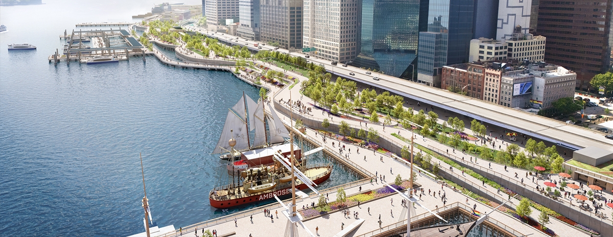 A waterfront cityscape featuring tall skyscrapers, a tree-lined promenade, docks with boats, and people walking along paths by the river under a bright, clear sky.